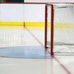 An empty ice hockey rink featuring a goal net