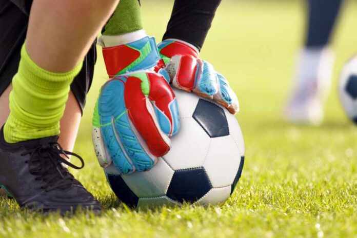 Youth,Goalkeeper,Training.,Kid,With,Goalie,Gloves,Holding,Football,On