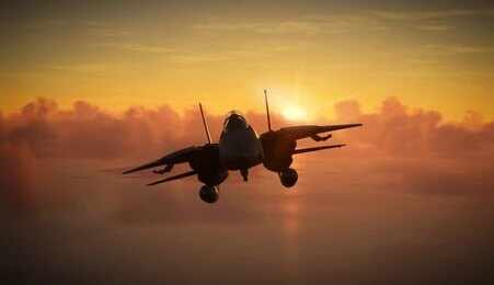 shutterstock_2483635841.jpg Military aircraft flying against a sunset backdrop
