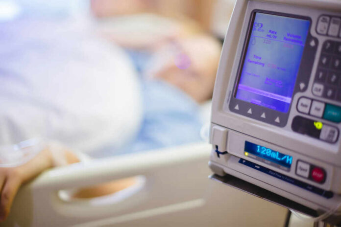 IV pump displaying medication flow rate in a hospital room