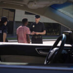 Teen Stabbing Rampage: High School Horror Police officers interacting with a civilian during a traffic stop