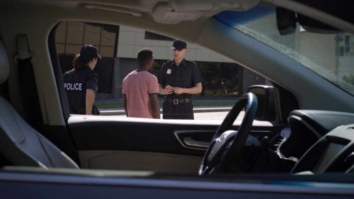 Police officers interacting with a civilian during a traffic stop