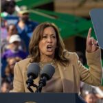 A woman passionately delivering a speech at a rally