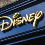 Golden Disney logo on a dark blue storefront