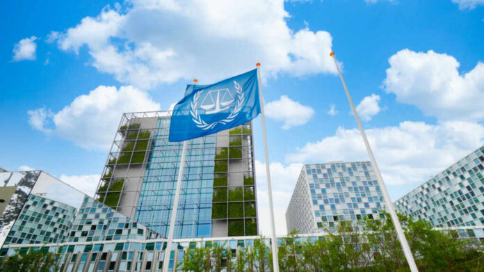 Modern building with UN flag in front under a blue sky with clouds