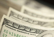 Close-up of several one hundred dollar bills stacked together