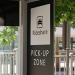Sign indicating a rideshare pickup zone in an urban setting