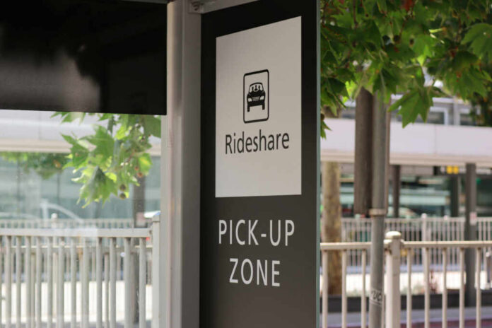 Sign indicating a rideshare pickup zone in an urban setting