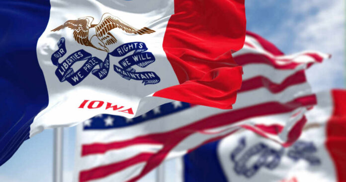 Iowa state flag prominently displayed with other flags in the background