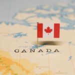 A small Canadian flag placed on a map indicating Canada