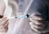 Cancer Hype Meets Ozempic Reality A healthcare professional preparing a syringe from a vial