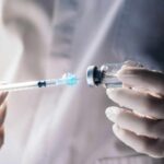 Cancer Hype Meets Ozempic Reality A healthcare professional preparing a syringe from a vial