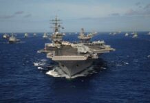 China’s Carrier Killer Trap Tightens An aircraft carrier surrounded by various naval ships in the ocean