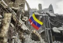 Venezuelan flag among ruins of a collapsed concrete building
