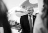 Inside The 702 Backdoor Fight A political figure speaking outdoors in front of an airplane