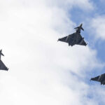 Russian Drone Triggers Alarms — Then This Three fighter jets flying in formation against a cloudy sky