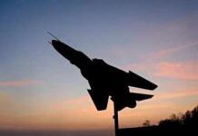 Pentagon’s $30B Bet: Old Jet, New War Silhouette of a fighter jet mounted on a pedestal at sunset