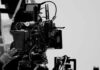 Olympic Shots Spark Censorship Brawl Close-up of a film camera with various cables and equipment in a studio setting
