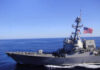 GAO Slams Navy’s Missile Moonshot A naval destroyer sailing in the ocean with an American flag