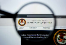 DOJ Drops Hammer On Maryland Close-up view of the Department of Justice website through a magnifying glass