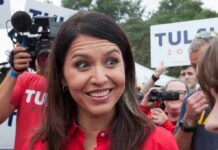 Waikīkī Pool Alarm: Political Bombshell woman smiling at outdoor event