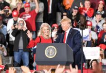political rally with two speakers at a podium