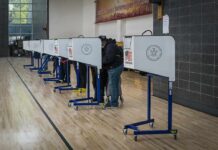 Bombshell? Where’s The Bomb Voters at polling booths in a gymnasium