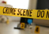 Beloved Teacher, Deadly Allegation Yellow crime scene tape with evidence markers in a room