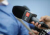 Tabloid Hype Outruns Proof A hand holding a CNN microphone during a news interview