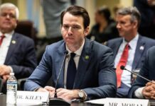 Anthropic Showdown Exposes Hidden Ban A man in a suit sitting at a table during a government hearing