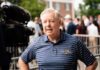 Sudden Senator Death Sparks Wild Poison Frenzy A man in a striped shirt speaking during a media interview at an outdoor event