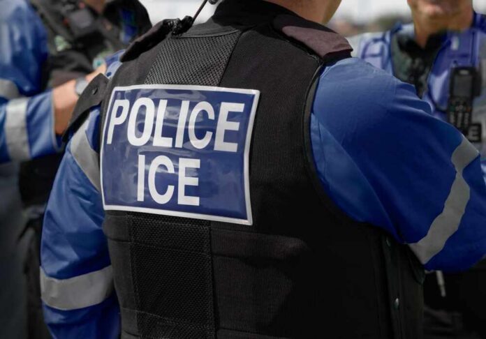 Ice,Police,Agent,-,Officer,Of,Immigration,And,Customs,Enforcement. Close-up of a police officer's vest with 'POLICE ICE' label