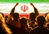 Iraq’s Power Funeral Goes Mega Crowd of people raising their fists in front of the Iranian flag