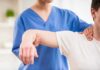 Deadly Lump Dismissed As ‘Strain’ Physical therapist guiding a patient's arm during shoulder exercise
